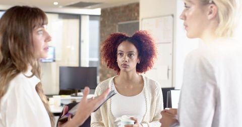 Diverse Female Professionals Collaborating in Modern Office Environment