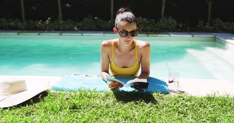Woman Reading Book by Backyard Pool on Sunny Day