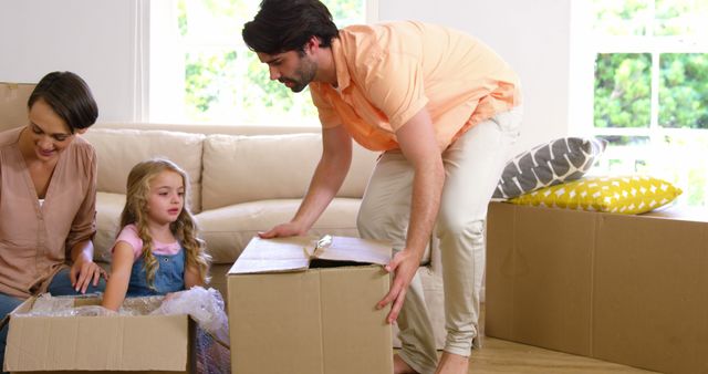 Family Moving into New Home with Cardboard Boxes and Excited Child - Download Free Stock Images Pikwizard.com