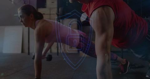 Couple performing plank with dumbbells and digital shield overlay in gym, moody core training