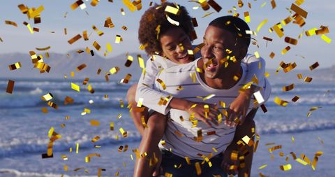 Celebratory Moment on Beach with Father and Son