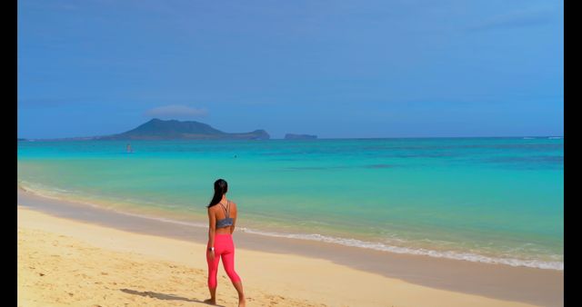 Woman in Pink Leggings Standing on Sunny Tropical Beach - Download Free Stock Photos Pikwizard.com