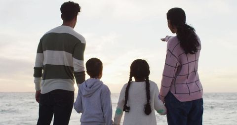 Family Bonding by the Ocean at Sunset