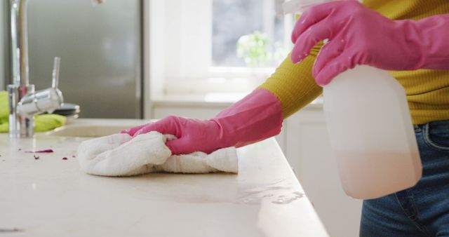 Midsection of biracial woman cleaning in kitchen, in slow motion - Download Free Stock Photos Pikwizard.com