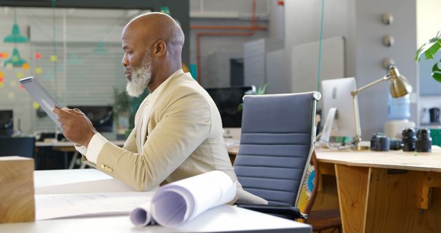 Focused African American Businessman Reviewing documents in Modern Office - Download Free Stock Images Pikwizard.com