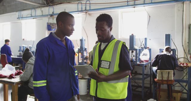 Employees Discussing Work Plans in Manufacturing Workshop - Download Free Stock Images Pikwizard.com