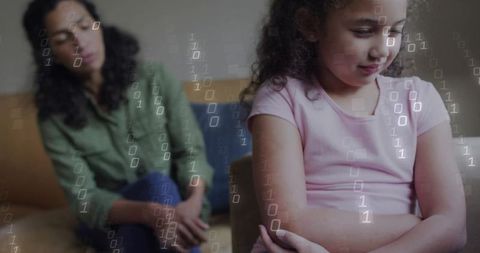 Caregiver sitting with pensive child on sofa, child crossing arms, digital binary overlay