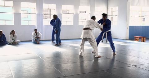 Group Practicing Martial Arts Techniques in Training Studio