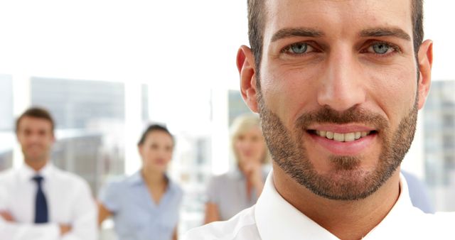 Confident Businessman Leading Diverse Team in Modern Office - Download Free Stock Images Pikwizard.com