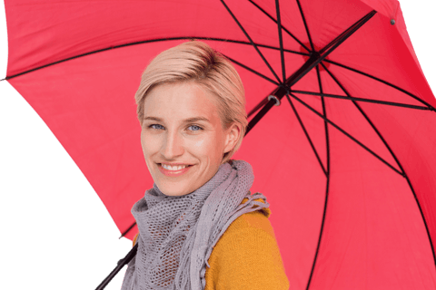 Smiling woman holding red transparent umbrella, bright positive background