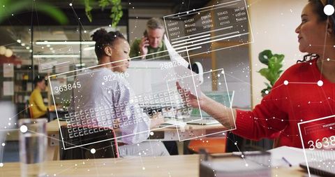 Coworkers exchanging document in modern coworking office with augmented reality overlays