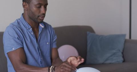 Person preparing balloons for celebration at home