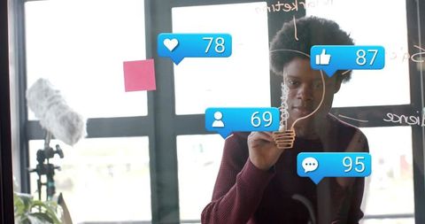 Creative Woman Brainstorming Ideas on Office Glass Board