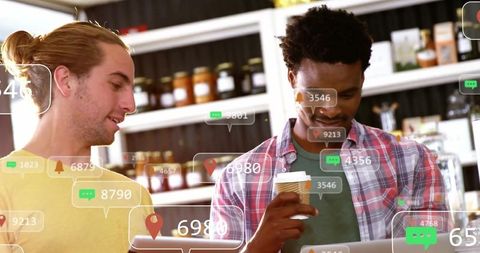 Colleagues Analyzing Digital Data in Modern Cafe