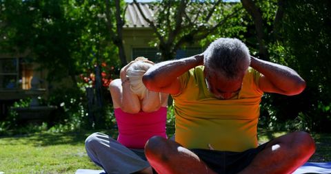 Senior Diverse Couple Practicing Yoga Outdoors