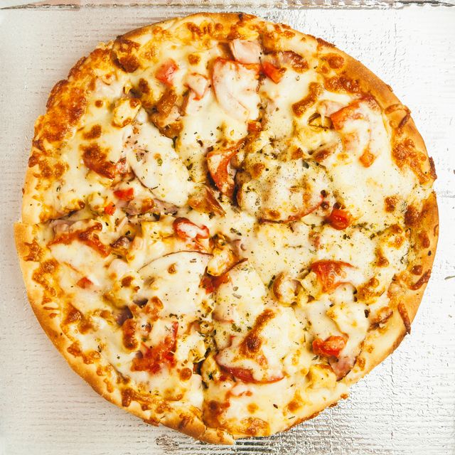 Perfect for marketing materials related to food, restaurants, or takeout services. Can be used in menus, online food delivery platforms, and culinary blogs. Highlights the appetizing nature of the pizza with a detailed focus on melted cheese and toppings.