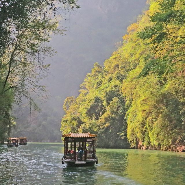 Tourists in Traditional Boats on Peaceful River by Forested Hills - Download Free Stock Photos Pikwizard.com