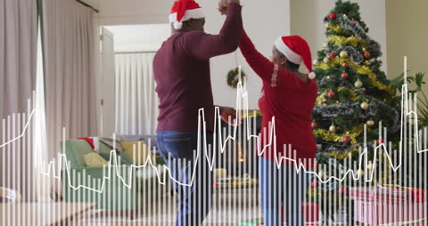 Festive Senior Couple Dancing Near Christmas Tree