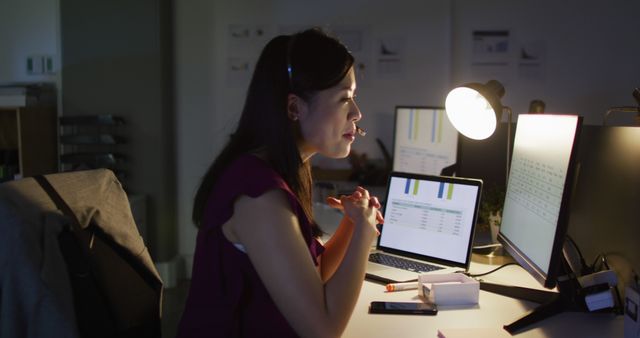 Image of asian female consultant working late in office. Business and working in office at night with technology concept.