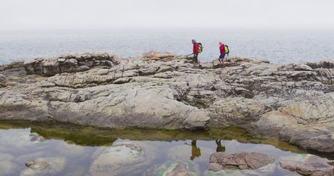 Senior Hikers Exploring Rocky Coastal Terrain - Download Free Stock Images Pikwizard.com