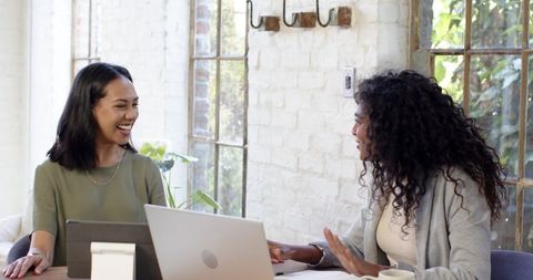 Diverse Professionals Engaging in Office Setting with Devices