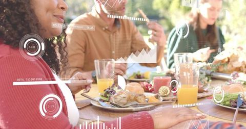 Friends dining outdoors enjoying roast chicken with floating digital data overlays