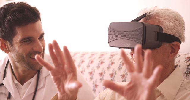Elderly man using virtual reality headset guided by healthcare professional. Ideal for illustrating advancements in medical technology, elderly care innovation, patient experiences with VR, digital health interventions, and the intersection of technology and healthcare. Suitable for healthcare websites, medical technology articles, and advertisements for VR products in the medical field.