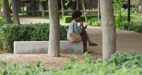 Digital nomad businesswoman relaxing in park with smartphone and lunch