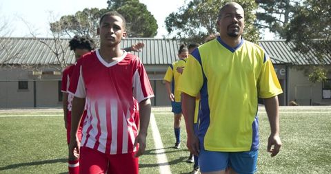 Diverse Soccer Team Preparing for Competitive Match on Sunny Day
