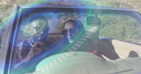 Sunlit convertible road trip couple driving with sunglasses, smartphone navigation, retro