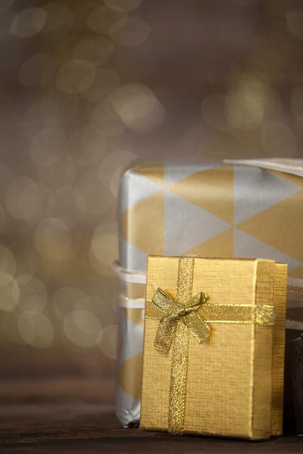 Close-up of wrapped gift boxes on wooden table during christmas time