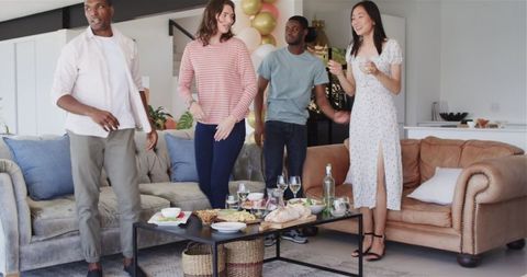 Diverse Group Enjoying Cheerful Housewarming Party Celebration