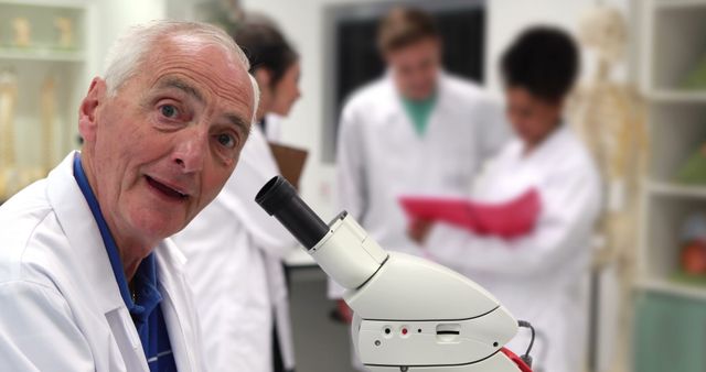 Senior Scientist Smiling While Working in Lab with Colleagues - Download Free Stock Images Pikwizard.com