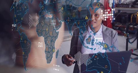 African american businesswoman pointing at augmented reality global map in tech lab