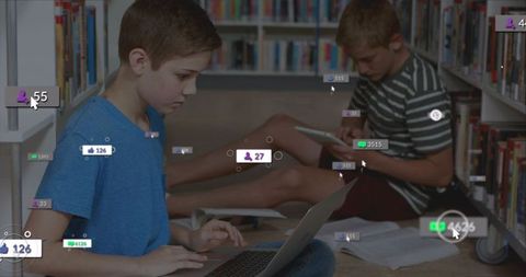 Teen Boys Studying with Laptop and Tablet in Library Aisle with Digital Overlays