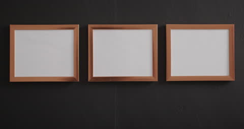 Three Wooden Frames on Black Wall with Blank Space