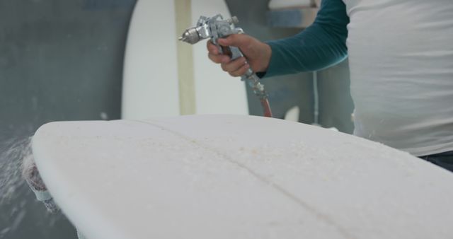 Craftsman Shaping Surfboard in Workshop Using Spray Gun - Download Free Stock Images Pikwizard.com