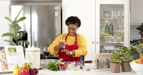 African American Woman in Kitchen Preparing Delicious Meal