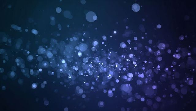 Glowing blue-purple bokeh particles creating depth in dark gradient light orbs