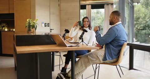 Diverse Coworkers Recording Podcast While Enjoying Coffee in Modern Home Office