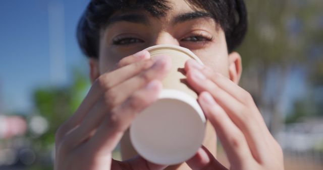 Young Man Drinking Takeaway Coffee in Outdoor Setting - Download Free Stock Images Pikwizard.com