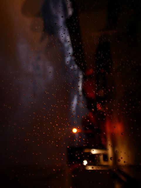 Rain droplets on window with city lights blurred in background - Download Free Stock Photos Pikwizard.com