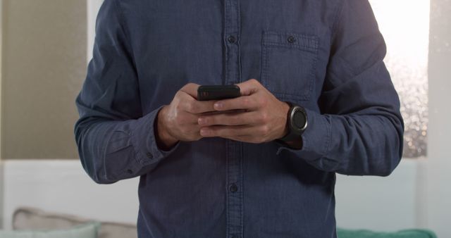 Man Wearing Blue Shirt Using Smartphone Indoors - Download Free Stock Images Pikwizard.com