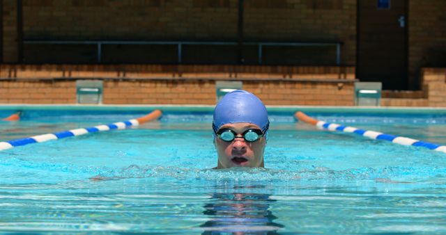 Young Athlete Swimming Freestyle in Outdoor Pool with Lap Lines - Download Free Stock Photos Pikwizard.com