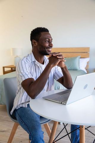 Man Working from Home at Laptop in Relaxed Setting