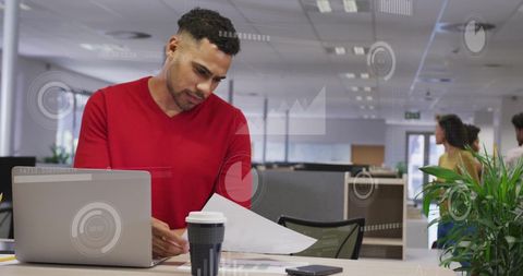 Businessman analyzing financial data at modern office desk