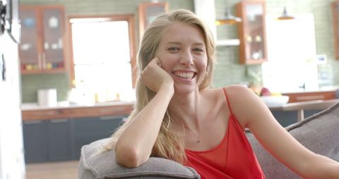 Smiling Young Woman Relaxed at Home in Cozy Interior