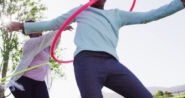 Kids Enjoying Hula Hooping Outdoors on a Sunny Day - Download Free Stock Images Pikwizard.com