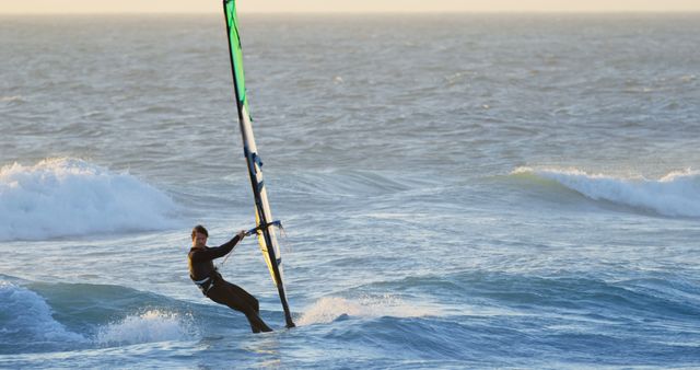 Sporty Person Windsurfing in Ocean during Sunset - Download Free Stock Images Pikwizard.com