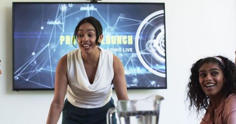 Diverse team in office meeting celebrating project launch